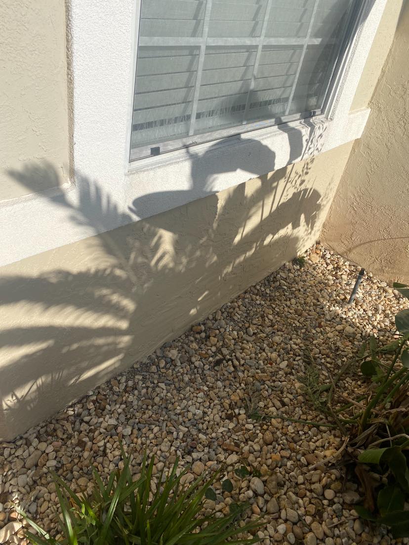 After — stucco repair completed, smooth seamless finish by Harvey's Restoration